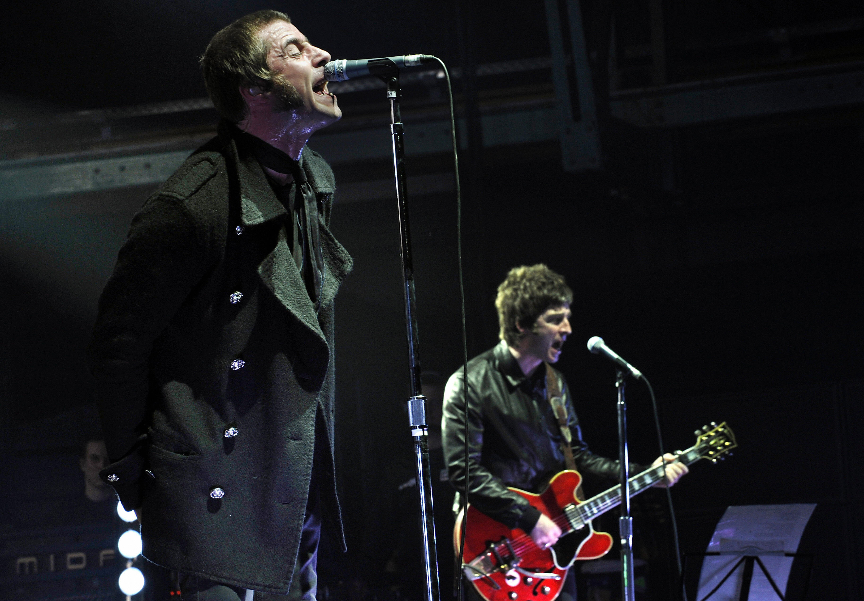Liam and Noel Gallagher (R) of the band